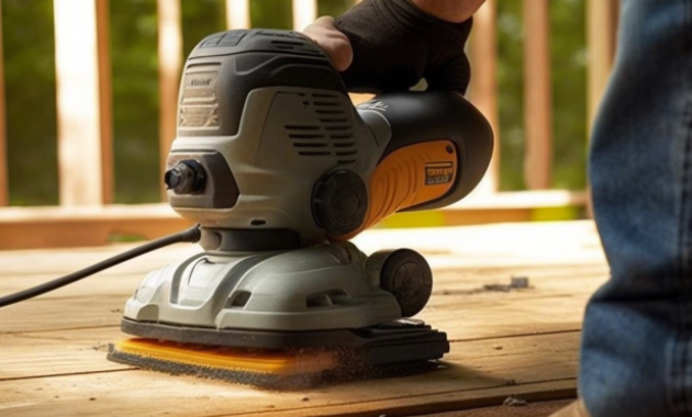 Person sanding old deck boards with a power sander.