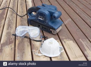Belt Sander On Partially Sanded Wooden Decking During Renovation pertaining to dimensions 1300 X 956