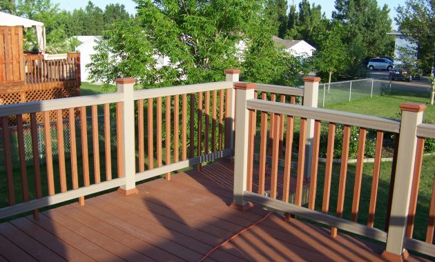 Ultradeck Natural Composite Decking: A close-up view of a beautiful and natural-looking deck made from a blend of wood fibers and recycled plastic. The decking material is designed to be durable and resistant to fading, staining, and mold growth.