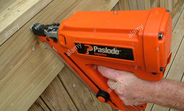 Nailing Timber Side Decking With An Orange Paslode Nail Gun Stock in measurements 1300 X 1058