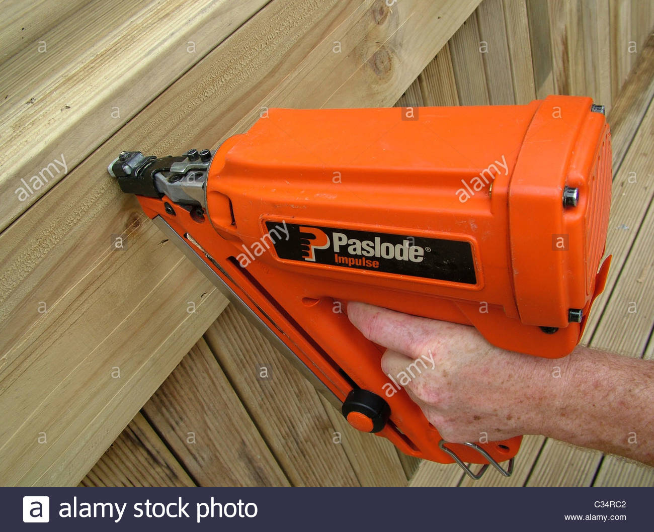 Nailing Timber Side Decking With An Orange Paslode Nail Gun Stock intended for size 1300 X 1058